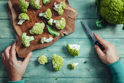 High angle view of hand holding food on table