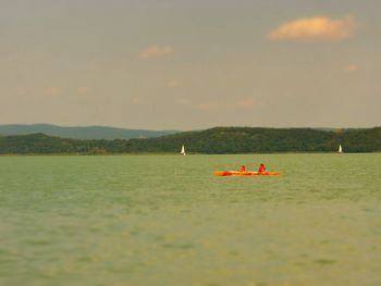 Boat floating on water against sky