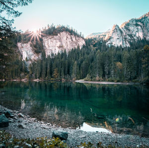 Scenic view of lake and mountains against clear sky