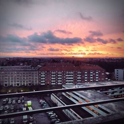 Aerial view of cityscape against sky during sunset