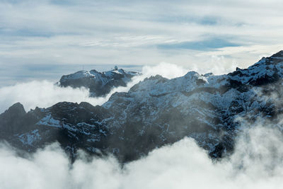 Overview of pico do areeiro peak covered with snow from pico ruivo footpath in madeira island