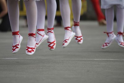 Low section of women standing on road