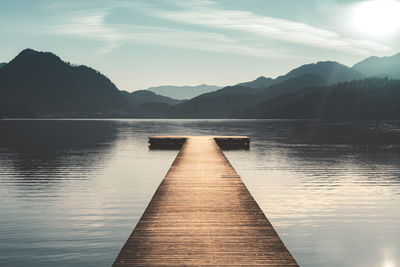 Pier over lake against mountains