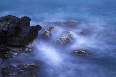 Scenic view of sea and rocks against sky