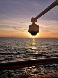 Silhouette boat in sea against sky during sunset