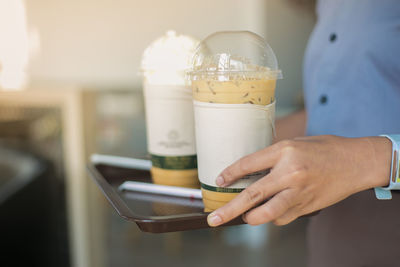 Close-up of woman hand holding drink