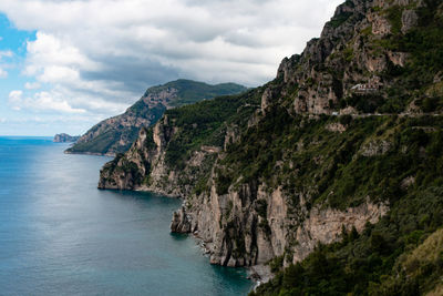 Scenic view of sea and mountains against sky