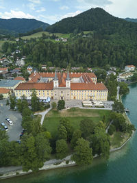 High angle view of townscape by sea against mountain