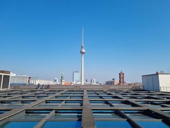 Low angle view of modern buildings against clear blue sky