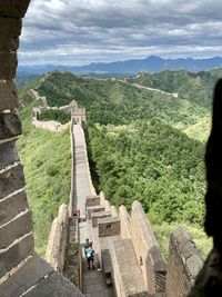 Great wall of china against cloudy sky seen through window