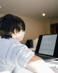 Distance learning. boy learns math looking a laptop. concept of online , home education, technology.