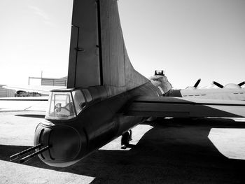 Airplane on runway against clear sky