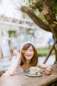 Portrait of a smiling girl sitting on table