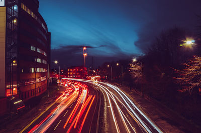 Light trails on road in city at night