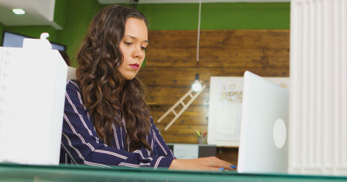 Portrait of young woman using mobile phone