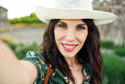 Close-up portrait of woman taking selfie while standing outdoors