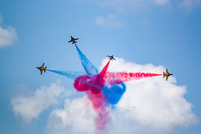 Low angle view of airshow against sky