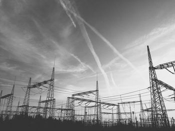 Low angle view of electricity pylon against sky