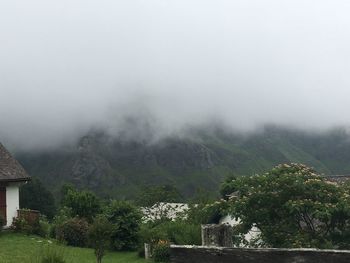 Scenic view of mountains against sky during foggy weather