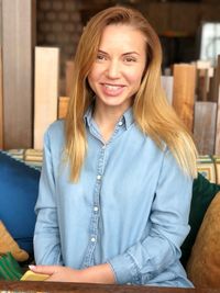 Portrait of smiling mid adult woman sitting in workshop