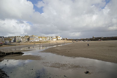 View of beach against cloudy sky