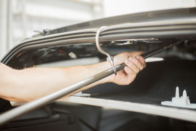 Close-up of man repairing car 