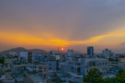 High angle view of buildings against sky during sunset