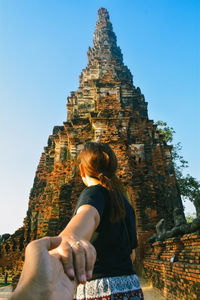 Close-up of couple holding hands at temple 