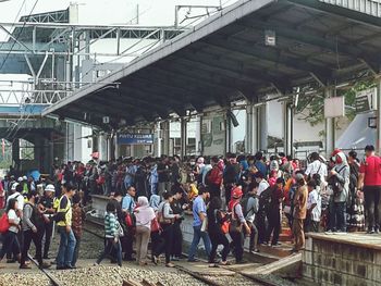 Group of people standing against built structure