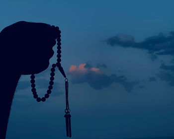 Spiritual moments of man holding rosary with faith 