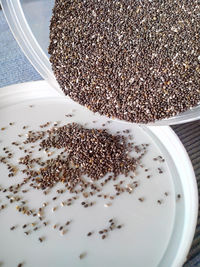 Chia seeds being poured on lid