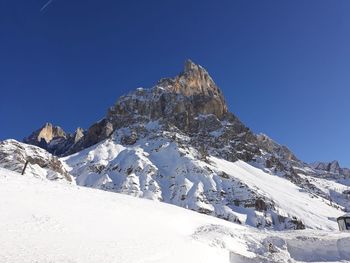 Scenic view of snowcapped mountains against clear blue sky