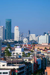 Cityscape against clear blue sky