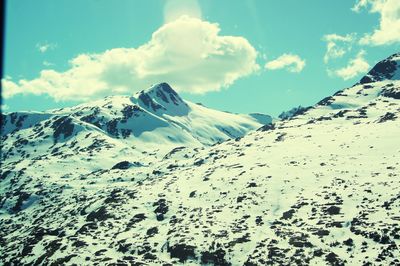 Scenic view of snowcapped mountains against sky