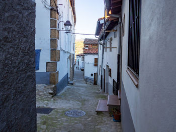 Narrow alley amidst buildings in town