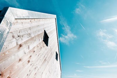 Low angle view of flag on building against sky