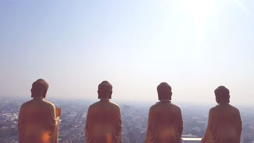 Buddha statue against clear sky during foggy weather