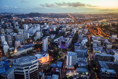 High angle view of illuminated city buildings against sky