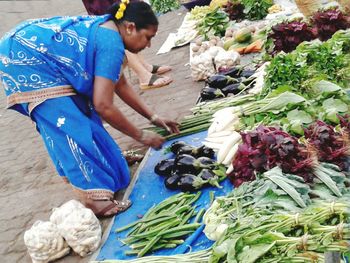 Midsection of man having food in market