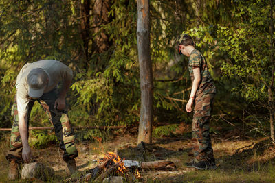 Rear view of man standing in forest