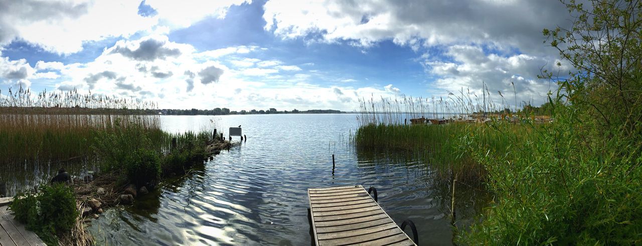 water, sky, cloud - sky, tranquility, tranquil scene, nature, cloudy, grass, plant, beauty in nature, scenics, cloud, lake, growth, sea, green color, day, river, pier, idyllic