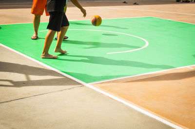 Low section of people walking on tiled floor