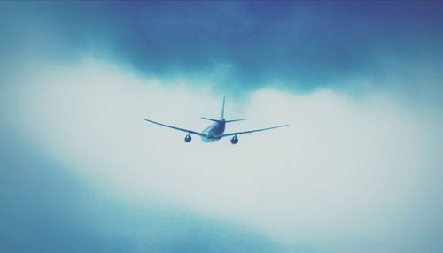Low angle view of airplane flying in sky