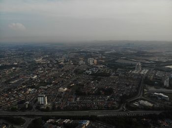 High angle view of illuminated city buildings against sky