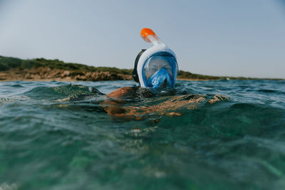 Close-up of woman snorkeling in sea