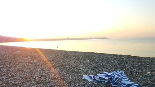 Scenic view of beach against sky during sunset