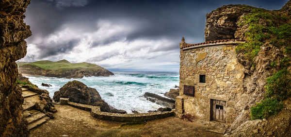 Panoramic view of calm sea against cloudy sky