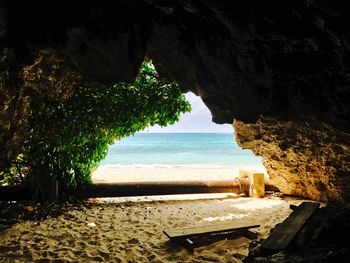 Scenic view of sea seen through cave