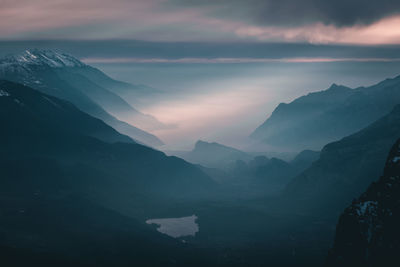 Scenic view of mountains against sky at sunset