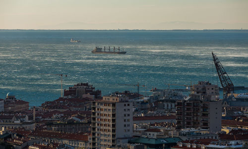 High angle view of sea against buildings in city